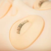 Interchangeable eyes with eyelashes for training head